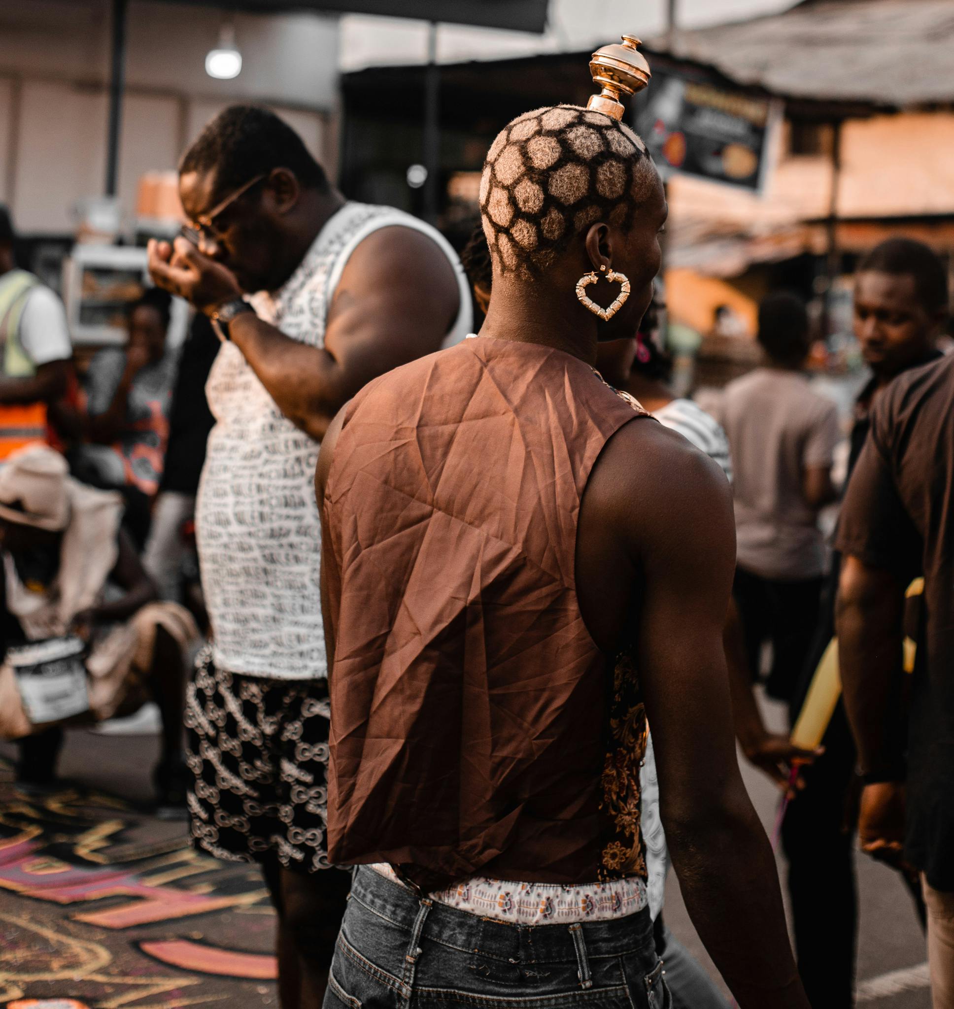 A bustling city street with diverse people showcasing unique fashion and urban culture.